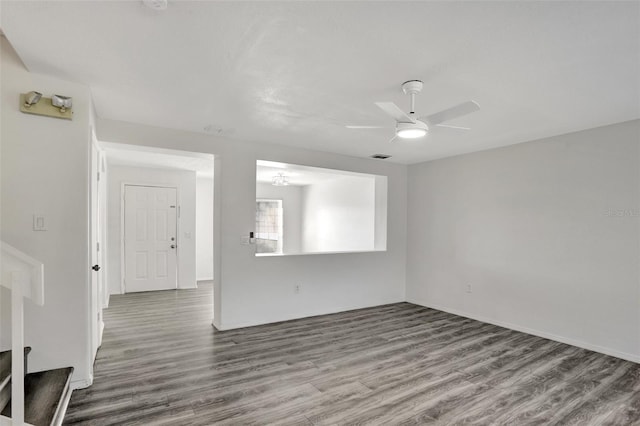 empty room with ceiling fan and hardwood / wood-style floors