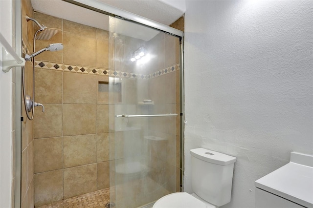 bathroom with walk in shower, vanity, and toilet