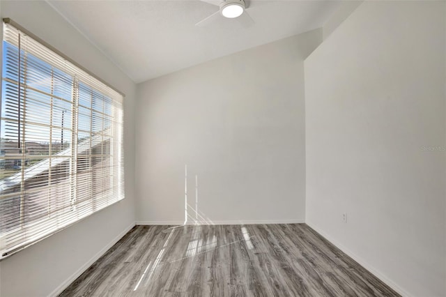 empty room with hardwood / wood-style floors and ceiling fan