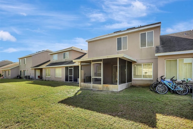 back of house with a yard, central AC unit, and a sunroom