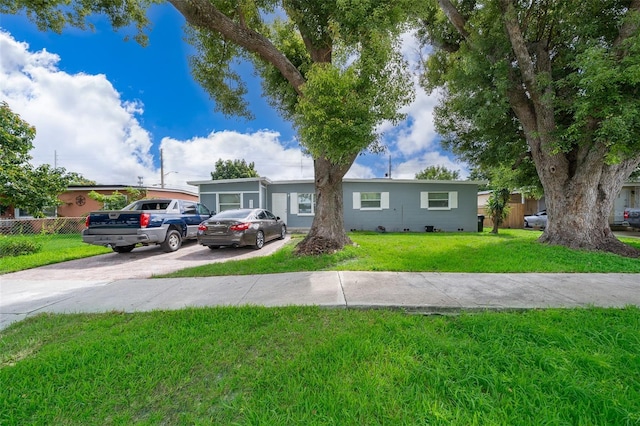 ranch-style home with a front lawn