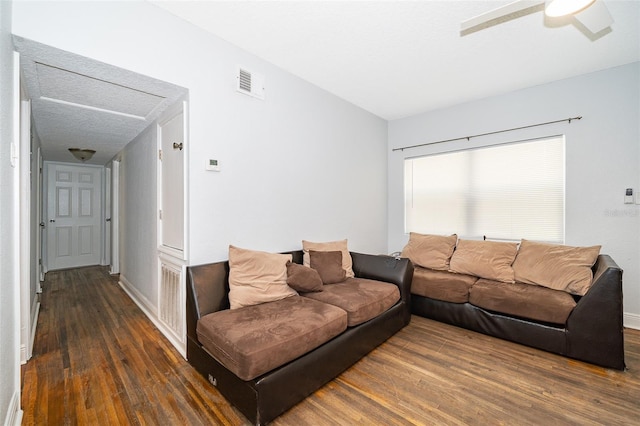 living room featuring dark hardwood / wood-style flooring and ceiling fan