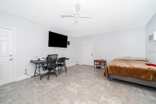 bedroom featuring ceiling fan and a textured ceiling