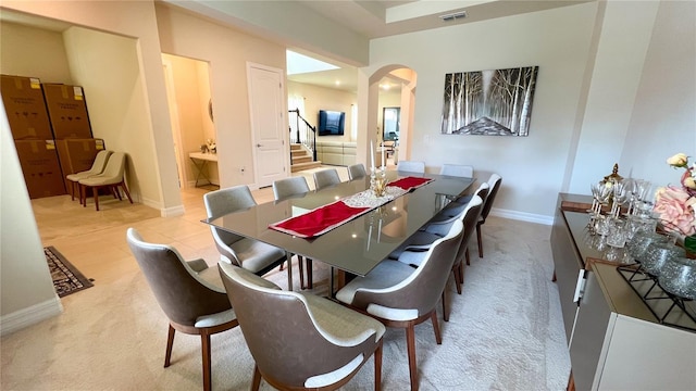 dining room featuring light colored carpet