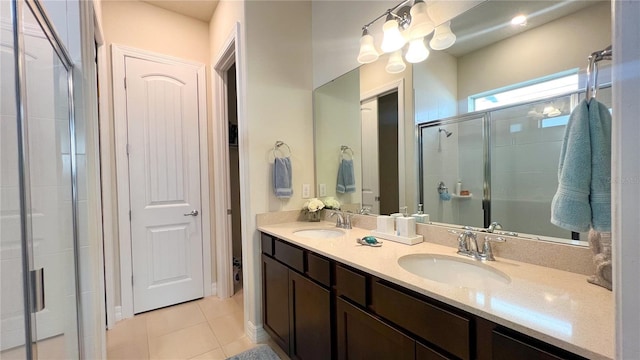 bathroom featuring vanity, a shower with shower door, and tile patterned floors