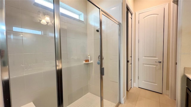 bathroom with tile patterned flooring, vanity, and walk in shower