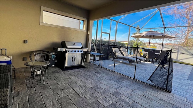 view of patio featuring area for grilling and glass enclosure