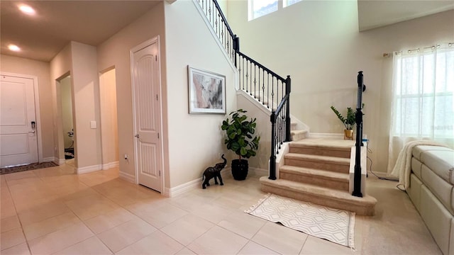 entryway with light tile patterned flooring