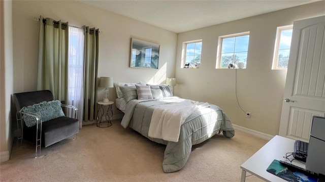 bedroom featuring light carpet