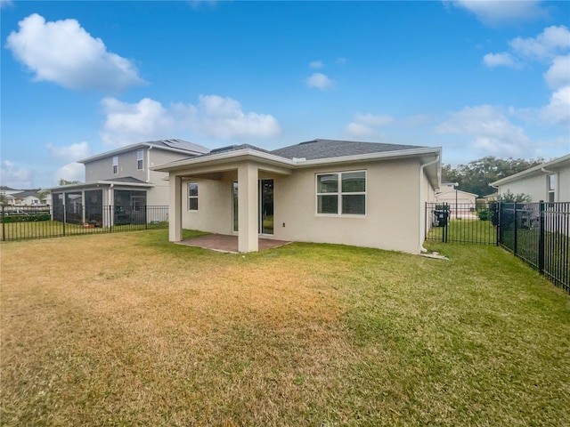 rear view of property with a patio and a lawn