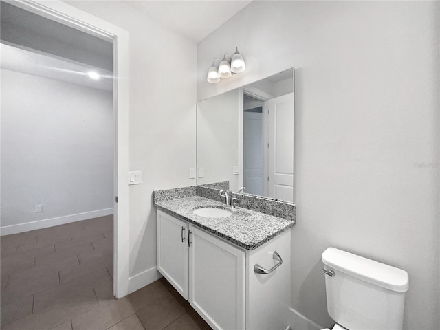 bathroom featuring vanity, tile patterned flooring, and toilet