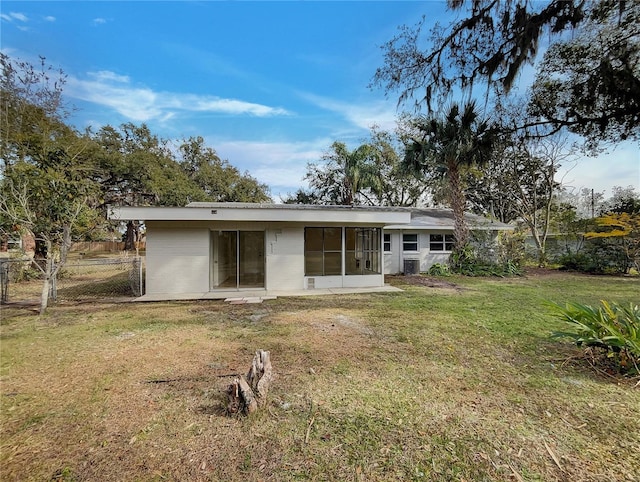 rear view of property featuring a yard