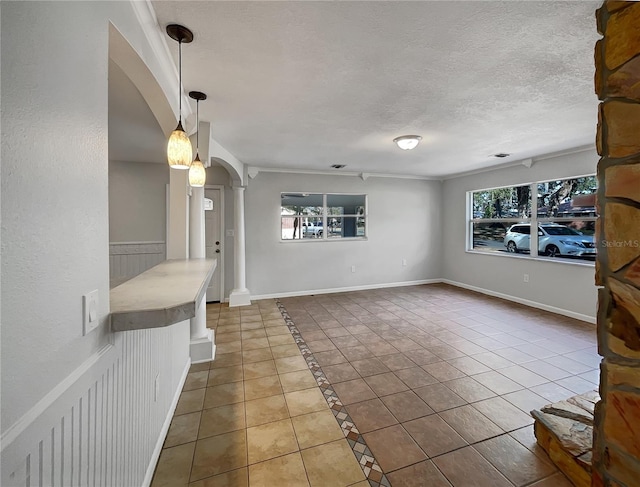 tiled living room with plenty of natural light and a textured ceiling