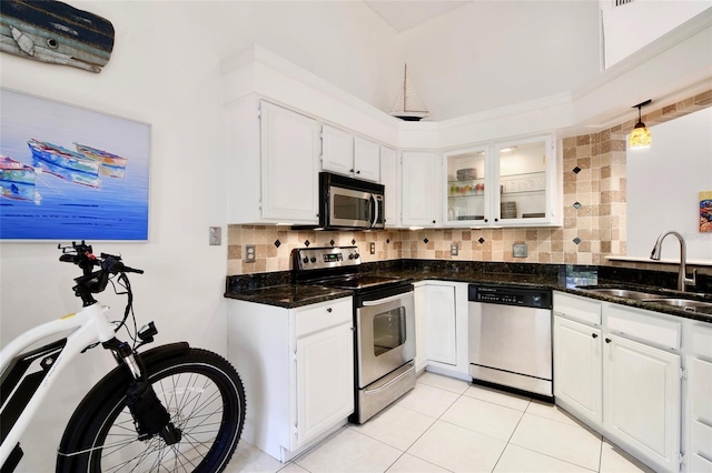 kitchen with white cabinetry, sink, dark stone counters, and appliances with stainless steel finishes