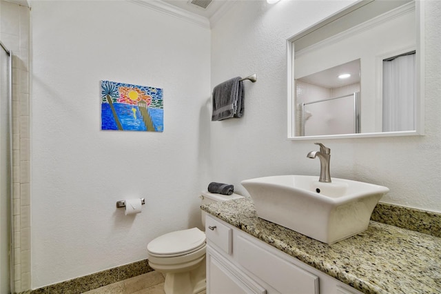 bathroom with toilet, vanity, ornamental molding, and a shower with door