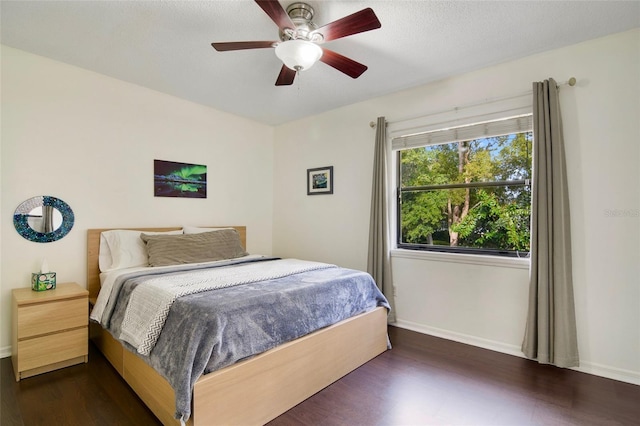 bedroom featuring dark wood-type flooring and ceiling fan