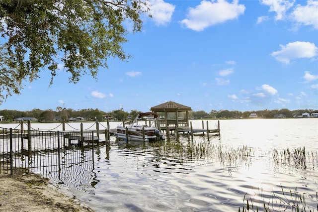 view of dock with a water view and a gazebo