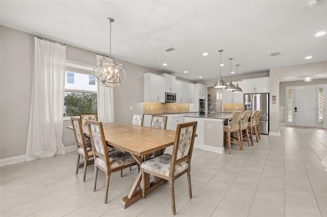 tiled dining area featuring a chandelier