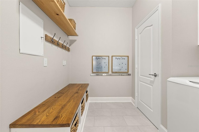 mudroom featuring washer / clothes dryer and light tile patterned floors