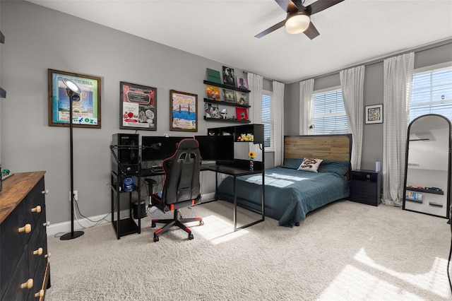 bedroom with ceiling fan, carpet floors, and multiple windows