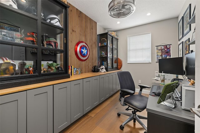 office space featuring a textured ceiling and light wood-type flooring