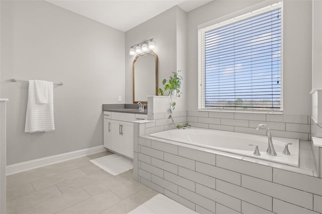 bathroom with vanity, tile patterned floors, and tiled bath