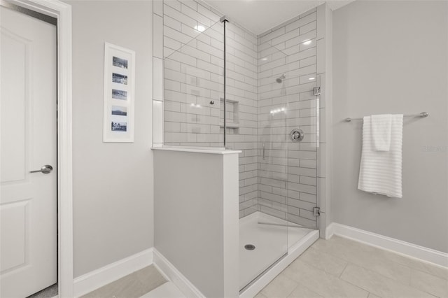 bathroom with tile patterned floors and a shower with shower door