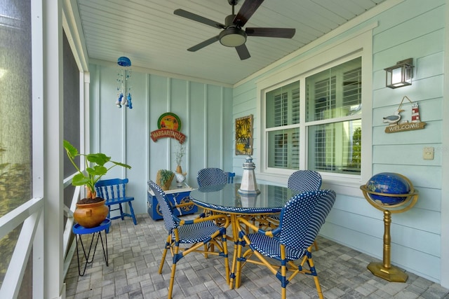 sunroom featuring a healthy amount of sunlight and ceiling fan