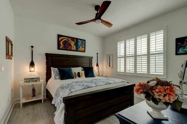 bedroom with ceiling fan and wood-type flooring