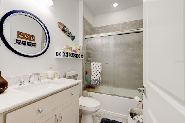 full bathroom featuring vanity, toilet, tile patterned flooring, and combined bath / shower with glass door