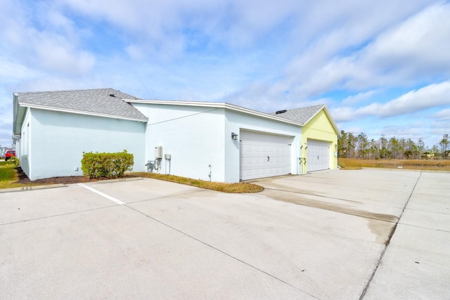 view of side of home featuring a garage