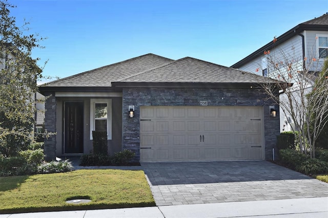 view of front of home featuring a garage and a front lawn