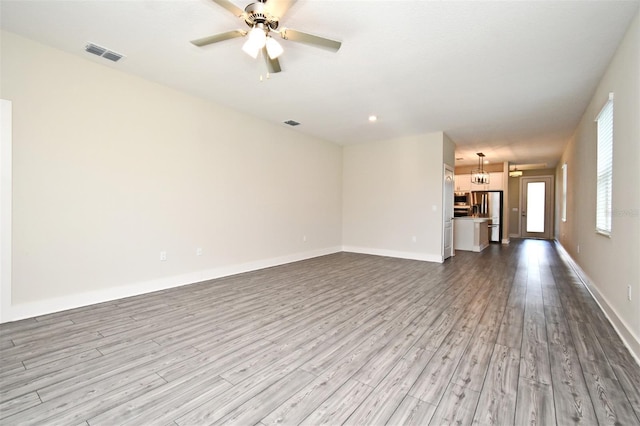 unfurnished living room featuring ceiling fan and light hardwood / wood-style floors