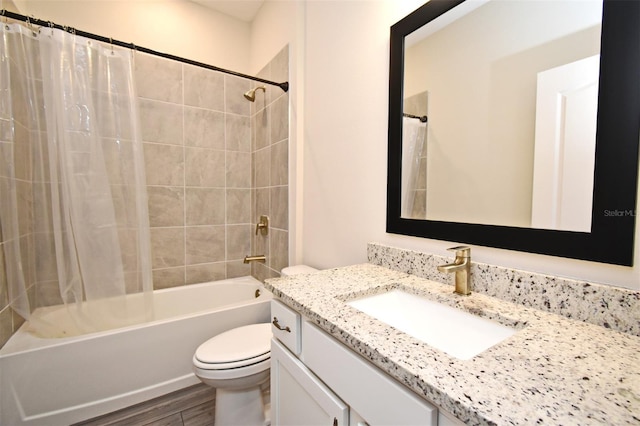 full bathroom featuring vanity, toilet, hardwood / wood-style floors, and shower / bath combo