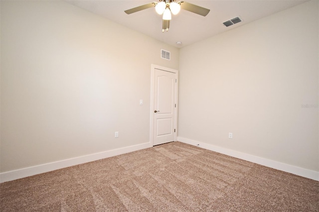 carpeted spare room with ceiling fan