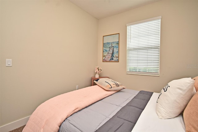carpeted bedroom featuring baseboards