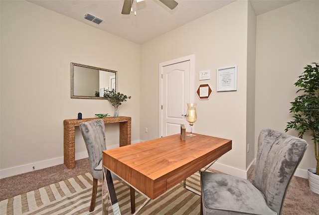 office space featuring a ceiling fan, carpet, baseboards, and visible vents