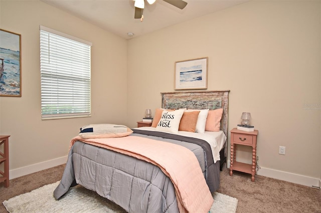 carpeted bedroom featuring baseboards and ceiling fan