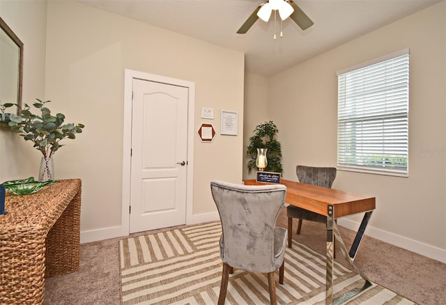 office with baseboards, light colored carpet, and ceiling fan