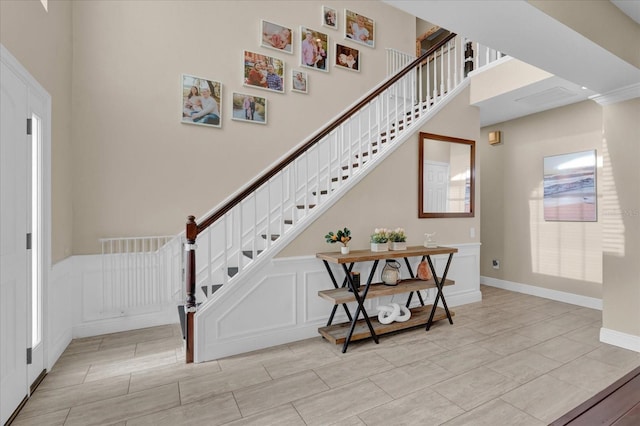 stairs featuring a towering ceiling