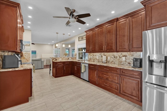 kitchen featuring sink, kitchen peninsula, pendant lighting, stainless steel appliances, and backsplash