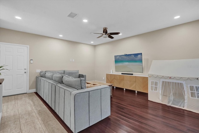 living room featuring hardwood / wood-style flooring and ceiling fan