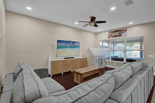 living room with dark hardwood / wood-style floors and ceiling fan