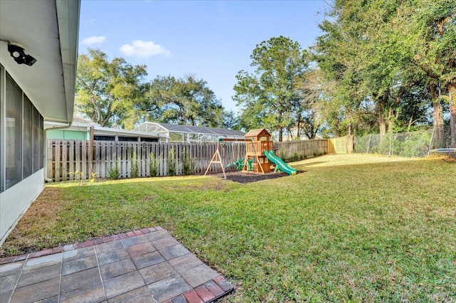 view of yard featuring a patio and a playground