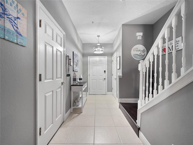 tiled foyer with a textured ceiling