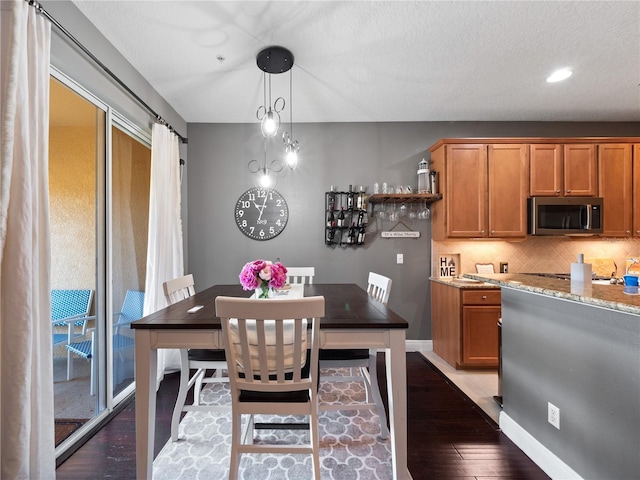 dining space featuring dark wood-type flooring