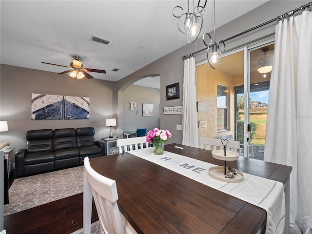 dining space featuring ceiling fan, dark hardwood / wood-style floors, and a textured ceiling