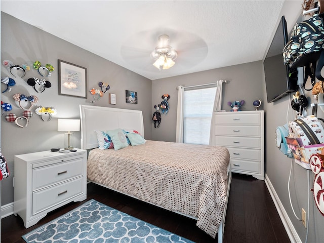 bedroom with ceiling fan and dark hardwood / wood-style flooring