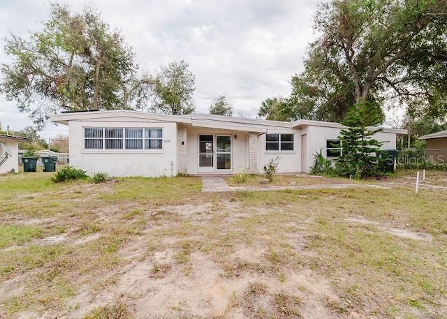 rear view of property featuring a yard