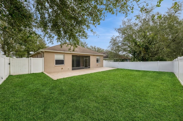 back of property with a patio area and a lawn